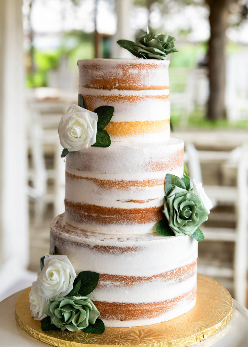 Naked cake French Buttercream design. Silk flowers placed offset.